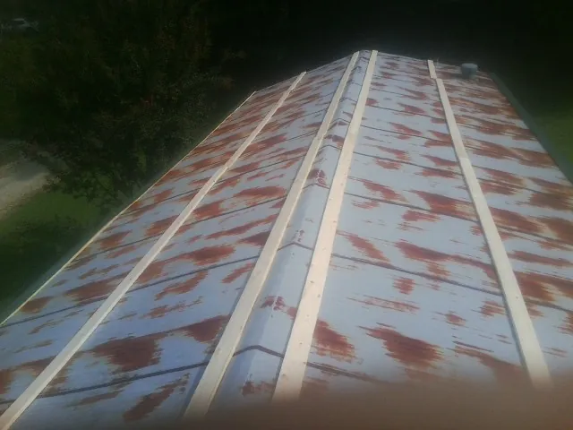 Rusted metal roof panels with new wood purlins before replacement — Storm Damage Roof Repair in Staples by Roofing Brothers